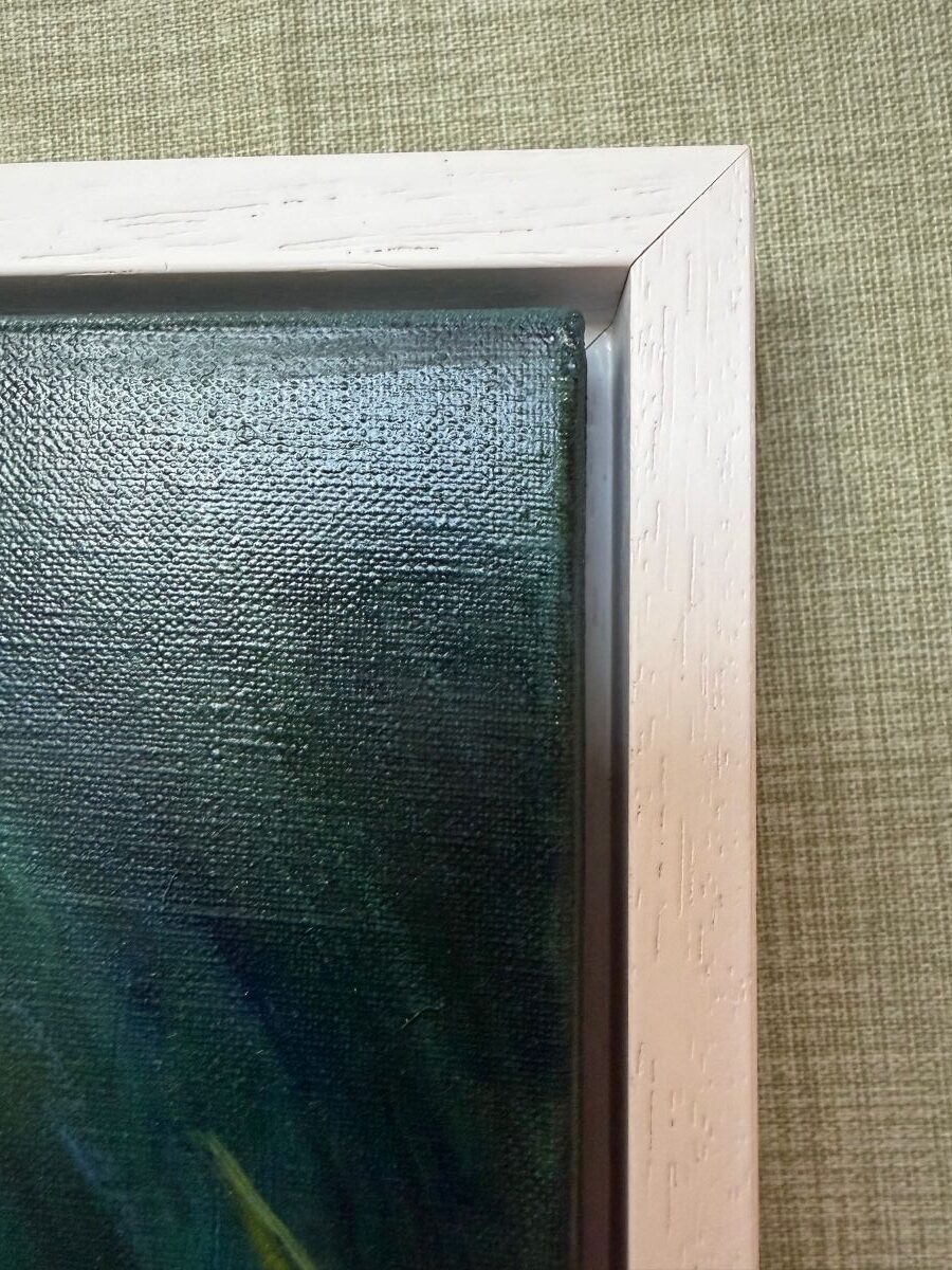 Edge of an oil painting of white calla lilies. A corner of a white wood floating frame.