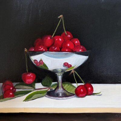 Oil painting of red cherries in a silver goblet with a dark background. The cherries around the goblet are reflected in the bowl of the goblet